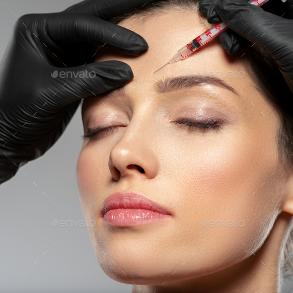 Caucasian Woman Getting Botox Cosmetic Injection In Forehead Woman Gets Botox Injection In Her 